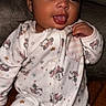 baby, infant, child, portrait, sitting, sofa, indoors, pajamas, onesie, minnie_mouse, disney, tongue_out, hand, face, eyes, smiling, candid, flash, brown_hair, cute