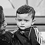 Noé a rejoint le concours — aidez-le/la à gagner de superbes lots ! adidas, black_and_white, casual, child, closeup, clothing, expression, face, glasses, hair, head, holding, jacket, outdoor, people, person, portrait, toddler, woman, young_child