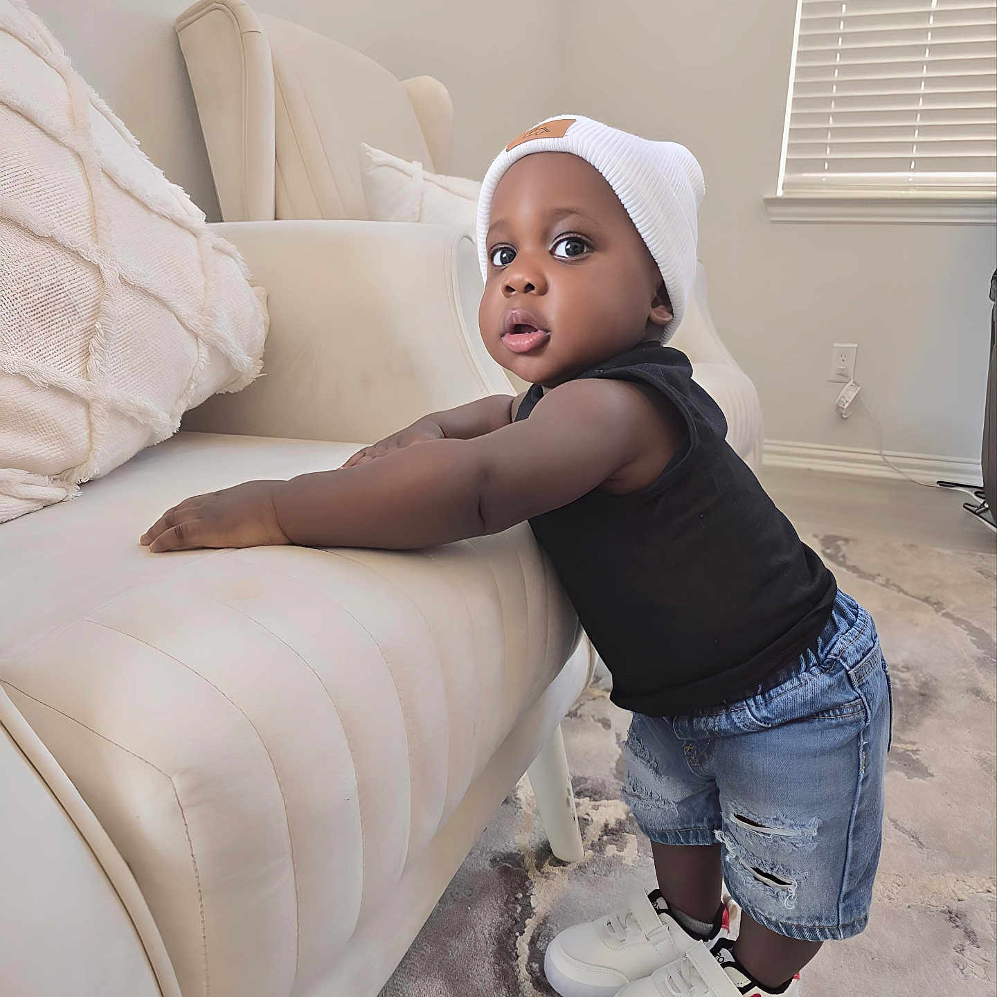 Kayden is registered to the contest to win money with this photo: bonnet, boy, child, clothing, couch, face, footwear, furniture, hat, head, jeans, male, pants, person, photography, portrait, shoe, sitting, sleeve, sneaker