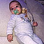 Milan participe au concours pour gagner de l'argent avec cette photo : baby, pacifier, couch, blanket, plush_toy, infant, clothing, face, hand, blue_eyes, indoor, comfort, relaxing, soft_furniture, child, person, long_sleeves, sitting, cute, home