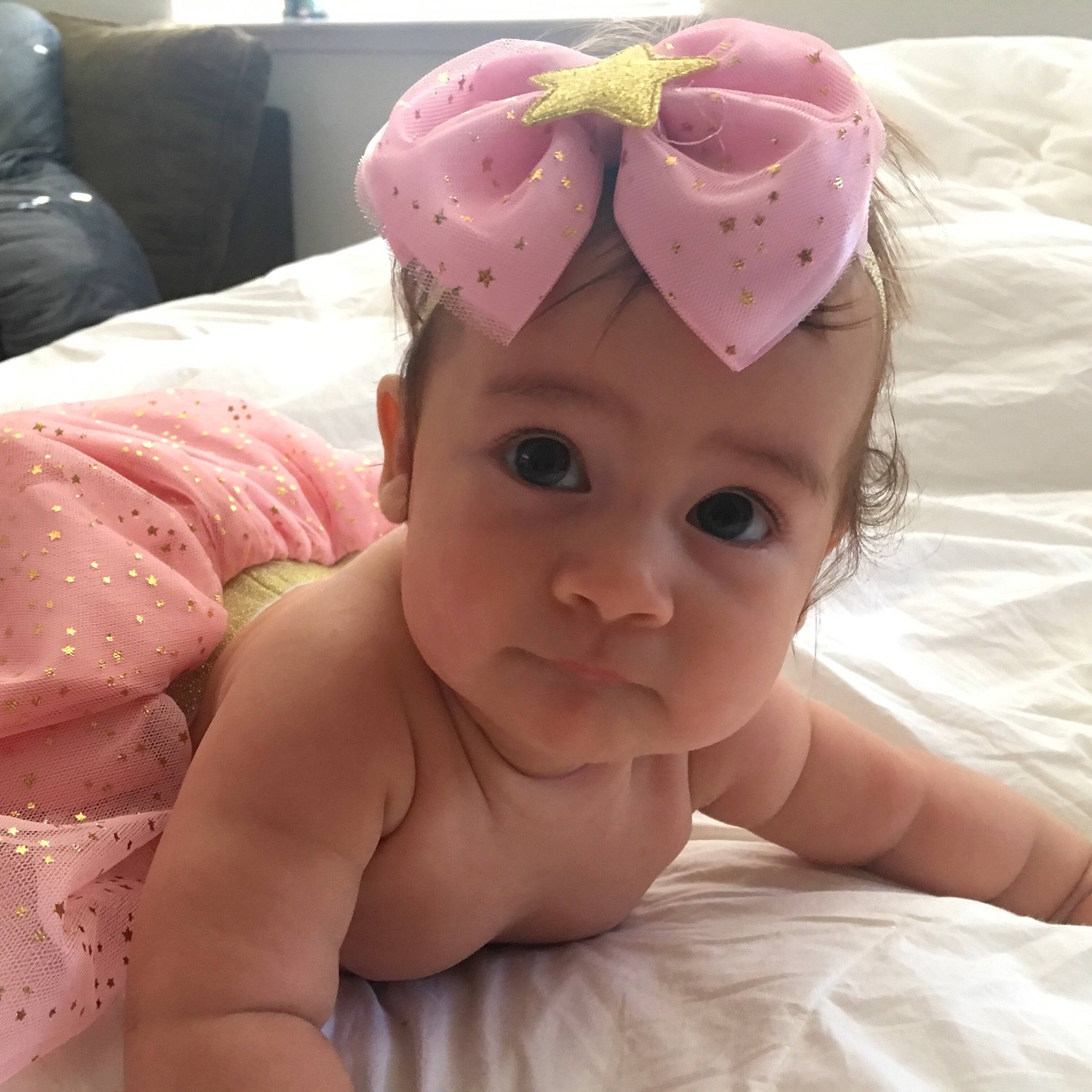 Eliana is registered to the contest to win money with this photo: baby, baby_products, birth, cheek, child, ear, eye, face, fashion_accessory, hair_accessory, head, headgear, mouth, neck, nose, person, pink, product, skin, smile