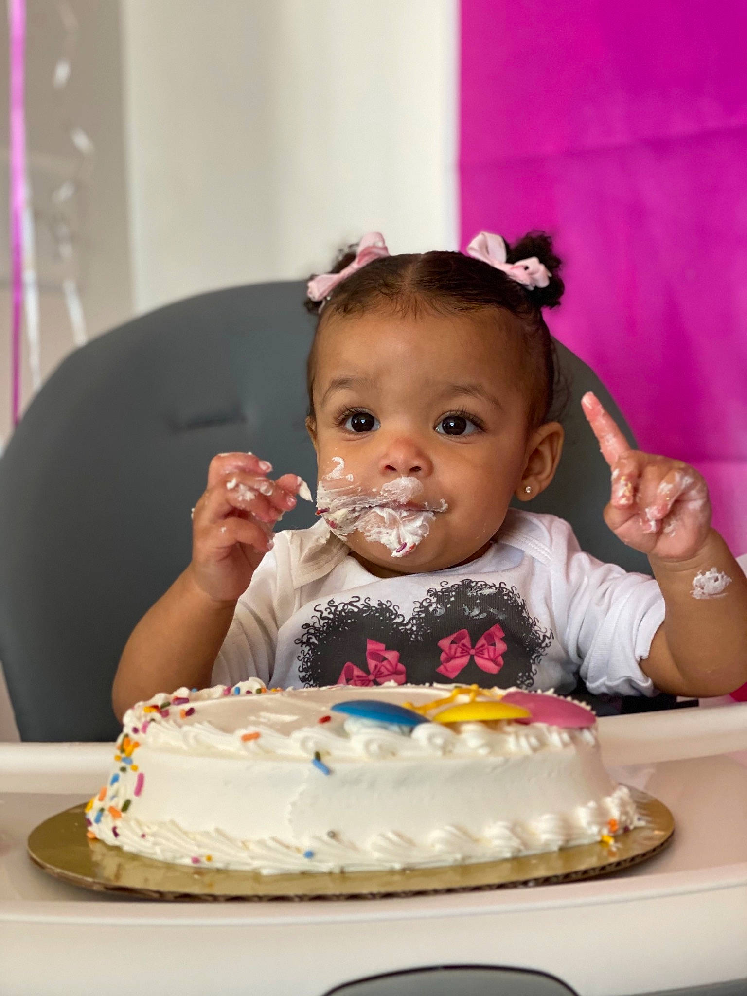 Kynsleigh is registered to the contest to win money with this photo: baby, birthday, birthday_cake, buttercream, cake, cake_decorating, cake_decorating_supply, cream, cuisine, dress, face, food, happy, person, pink, plate, sugar_cake, sugar_paste, table, tableware
