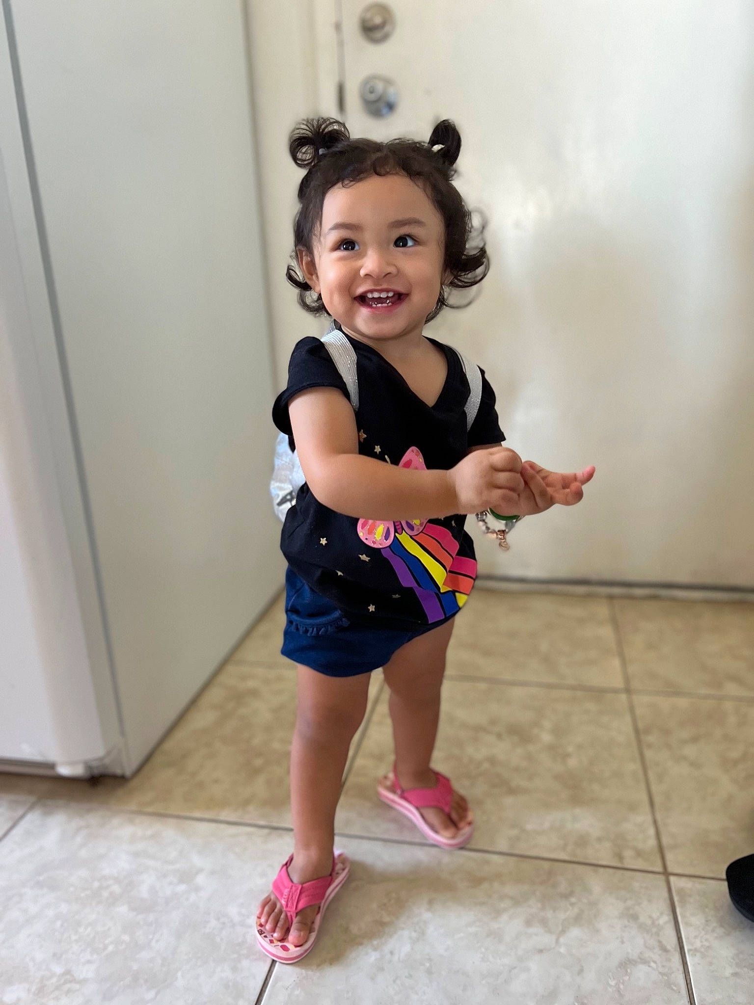Kyla joined the competition — help win amazing prizes! baby_toddler_clothing, electric_blue, event, flooring, hair, happy, human_leg, joy, knee, leg, neck, pattern, person, pink, sandal, shoe, sleeve, smile, sneakers, sock