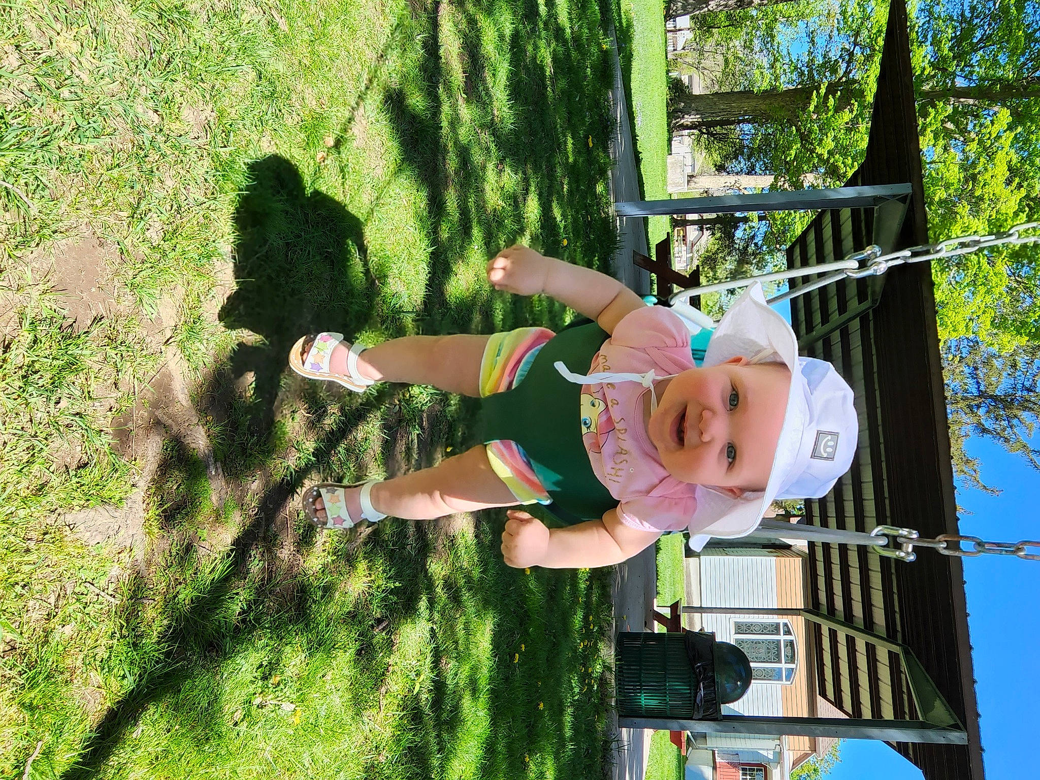Ava is registered to the contest to win money with this photo: baby, child, fun, grass, green, happy, hat, headwear, landscape, leisure, people_in_nature, person, plant, play, recreation, shadow, shorts, smile, sun_hat, toddler