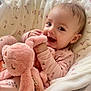 Kiara joined the competition — help win amazing prizes! baby, child, smiling, stuffed_animal, pink, blanket, cozy, indoor, cute, happy, soft_toy, face, infant, pajamas, plush, toddler, comfort, sleepwear, lying_down, cuddling
