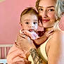 Kiara joined the competition — help win amazing prizes! baby, woman, holding, smile, tattoo, arm, pink, dress, nursery, cradle, face, portrait, child, person, indoor, cute, happy, skin, young, parent