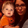 Jaxson joined the competition — help win amazing prizes! child, baby, adult, woman, portrait, selfie, smiling, duck_face, glasses, orange_shirt, autumn, halloween, pumpkin, warm_lighting, indoor, family, parent, closeup, long_hair, wood_background