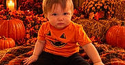 Jaxson is registered to the contest to win money with this photo: baby, child, infant, portrait, sitting, autumn, halloween, pumpkin, pumpkin_patch, orange_shirt, costume, leaves, hay, lantern, candle, outdoor, fall_decor, cozy, face, black_pants