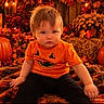 autumn, baby, black_pants, candle, child, costume, cozy, face, fall_decor, halloween, hay, infant, lantern, leaves, orange_shirt, outdoor, portrait, pumpkin, pumpkin_patch, sitting