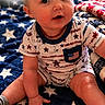 baby, blanket, blue, celebration, child, cute, fireworks, flag, holiday, indoors, infant, memorial_day, patriotic, portrait, red, sitting, smiling, stars, stripes, white