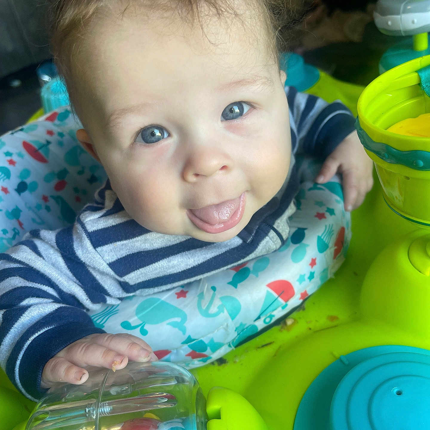 Milo is registered to the contest to win money with this photo: baby, blue_eyes, child, closeup, colorful, cute, face, hand, happy, indoor, infant, person, plastic_toy, play_station, playtime, smiling, striped_shirt, tongue_out, toy, young_child