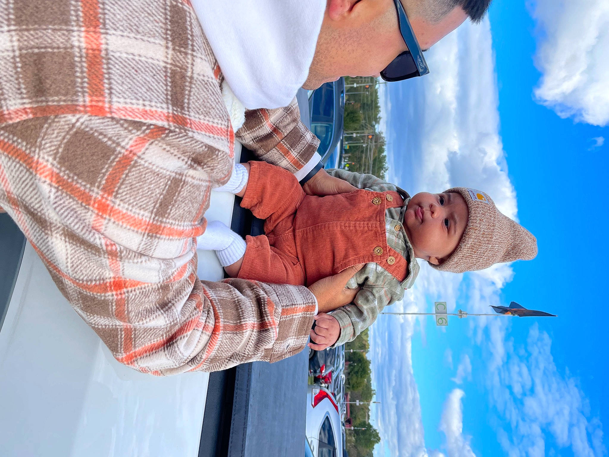 Saint is registered to the contest to win money with this photo: blue, child, cloud, electric_blue, fun, gesture, happy, hat, headwear, leisure, pattern, person, plaid, recreation, sky, tartan, toddler, travel, tree, vacation