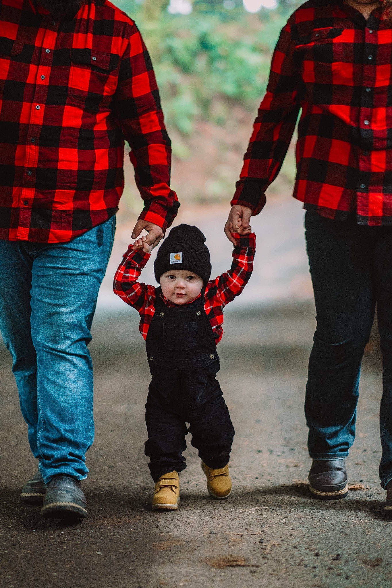 Bailey is registered to the contest to win money with this photo: footwear, fun, gesture, happy, headwear, holding_hands, human_body, interaction, jeans, people_in_nature, person, plaid, product, red, shoe, sleeve, sneakers, street_fashion, tartan, toddler