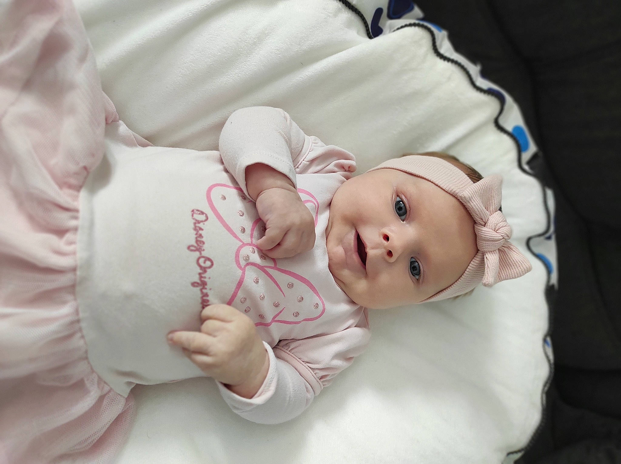 Maëlle participe au concours pour gagner de l'argent avec cette photo : baby, baby_products, baby_sleeping, baby_toddler_clothing, cheek, child, comfort, gesture, happy, hat, headwear, linens, pattern, person, pink, portrait_photography, product, skin, sleeve, textile