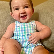 Everett joined the competition — help win amazing prizes! baby, infant, smiling, happy, child, cute, romper, clothing, sitting, couch, furniture, indoors, face, cheeks, skin, person, portrait, hands, legs, warm_lighting