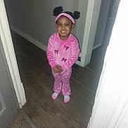 Teneyah joined the competition — help win amazing prizes! child, girl, smile, pajamas, pink_clothing, headband, pigtails, indoors, hallway, wood_floor, carpet, doorframe, standing, happy, person, young_child, cute, portrait, home, fashion