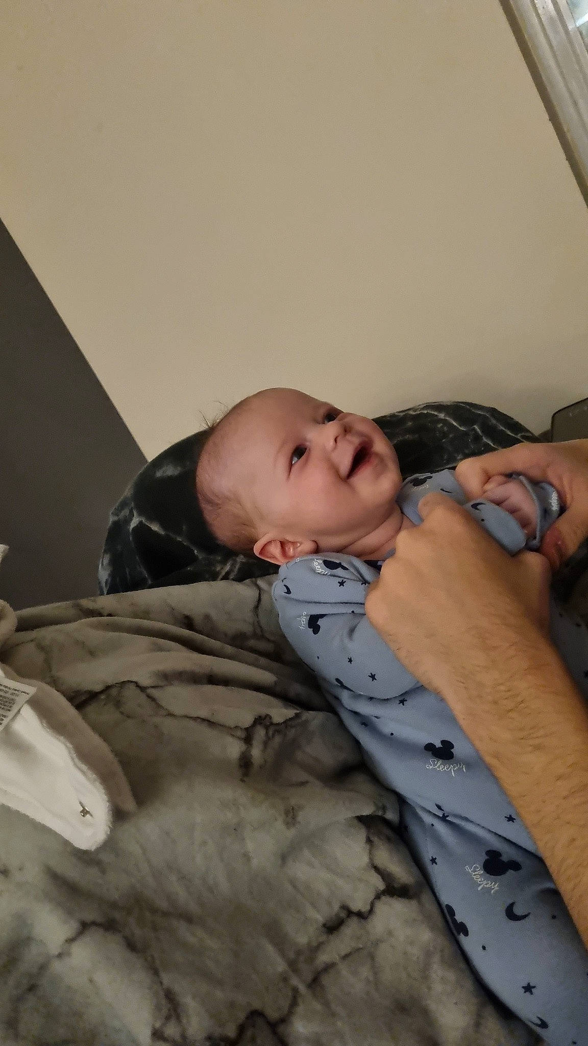 Johnathan is registered to the contest to win money with this photo: baby, baby_products, child, comfort, couch, elbow, facial_expression, flooring, fun, happy, human_leg, knee, linens, person, room, sitting, sleep, smile, thigh, toddler