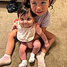 children, siblings, baby, toddler, girl, sisters, portrait, smiling, sitting, hugging, indoor, home, carpet, floor, clothing, dress, shirt, socks, shoes, family