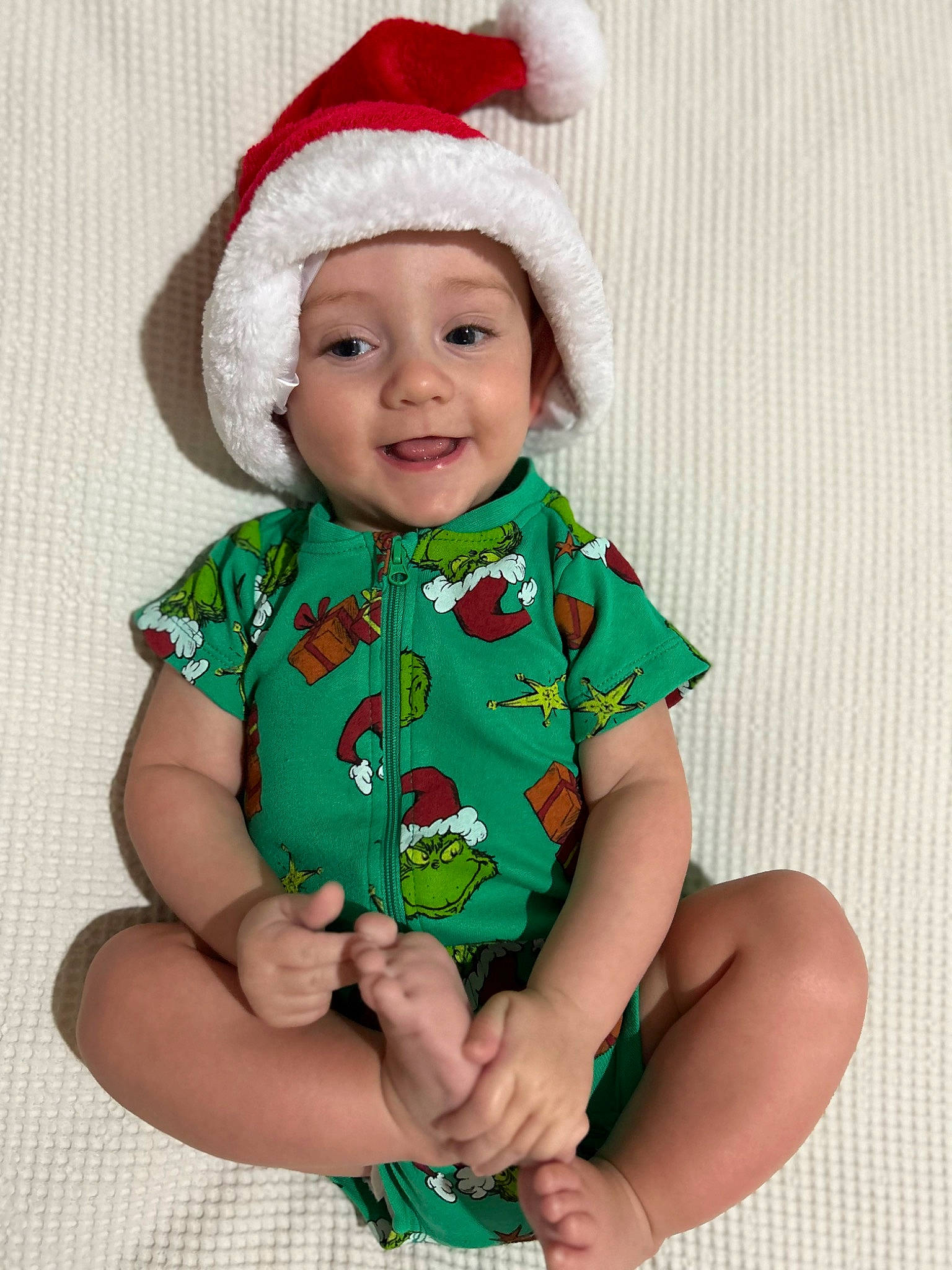 Lyric joined the competition — help win amazing prizes! baby, baby_toddler_clothing, cap, child, costume_hat, dress, facial_expression, finger, gesture, green, hand, happy, hat, head, headwear, human_body, joy, outerwear, person, sleeve