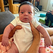Vida joined the competition — help win amazing prizes! adult, baby, blanket, carpet, casual, couch, curious, furniture, hands, home, indoor, infant, living_room, person, seated, shelves, skin, soft, television, white_onesie