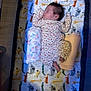 Vida is registered to the contest to win money with this photo: baby, sleeping, crib, blanket, floral_clothing, rolled_blanket, animal_pattern, infant, soft_lighting, peaceful, bedtime, cozy, nursery, child, sleepwear, newborn, resting, indoors, cute, portrait
