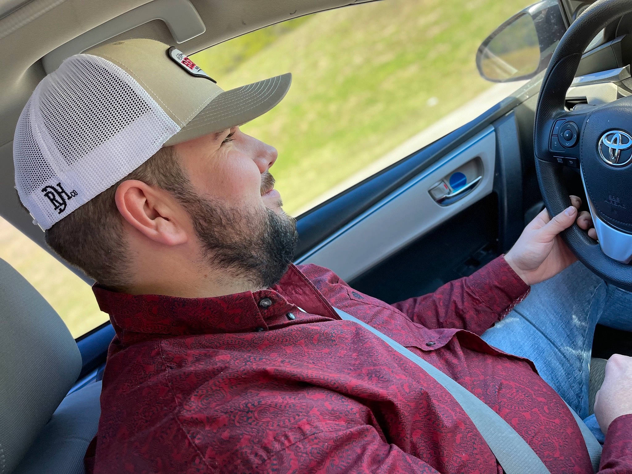 Magnolia is registered to the contest to win money with this photo: auto_part, automotive_design, automotive_exterior, automotive_mirror, baseball_cap, beard, cap, car, car_seat, gear_shift, hat, headgear, headwear, mammal, motor_vehicle, person, personal_luxury_car, rear_view_mirror, steering_wheel, vehicle