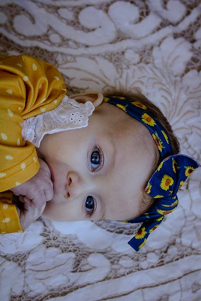 Magnolia is registered to the contest to win money with this photo: baby, baby_products, baby_sleeping, baby_toddler_clothing, baby_toys, cheek, child, eyelash, fashion_accessory, head, headgear, headwear, linens, lip, nose, pattern, person, portrait_photography, skin, toddler