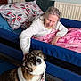 Bonnie is registered to the contest to win money with this photo: bed, blanket, canine, collar, comfort, dog, elderly_person, floor_mat, fur, furniture, hand, home, human, indoor, interaction, pet, pillow, radiator, smile, wall_art