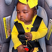 Jersi joined the competition — help win amazing prizes! baby, infant, sleeping, car_seat, yellow_bow, yellow_sweater, sunflower_pants, child, seatbelt, closed_eyes, cute, indoors, safety_harness, clothing, adorable, resting, infant_fashion, headband, toddler, black_hair