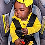 baby, infant, sleeping, car_seat, yellow_bow, yellow_sweater, sunflower_pants, child, seatbelt, closed_eyes, cute, indoors, safety_harness, clothing, adorable, resting, infant_fashion, headband, toddler, black_hair