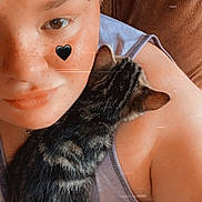Archie joined the competition — help win amazing prizes! casual_clothing, cat, closeup, comfort, couch, cute, eyebrow_piercing, face, feline, heart_sticker, indoor, kitten, person, pet, portrait, relaxation, shoulder, skin, snuggling, tabby_cat