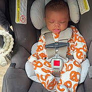 Caspian joined the competition — help win amazing prizes! baby, buckled, car_seat, child, close_up, gray, harness, headrest, indoors, infant, orange, patterned_clothing, peaceful, photograph, portrait, resting, safety, sleeping, transportation, vehicle
