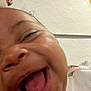 Rashawn is registered to the contest to win money with this photo: baby, blur, child, close_up, cute, expression, face, happy, head, human, indoor, infant, joy, laughing, mouth_open, person, skin, texture, tongue, wall
