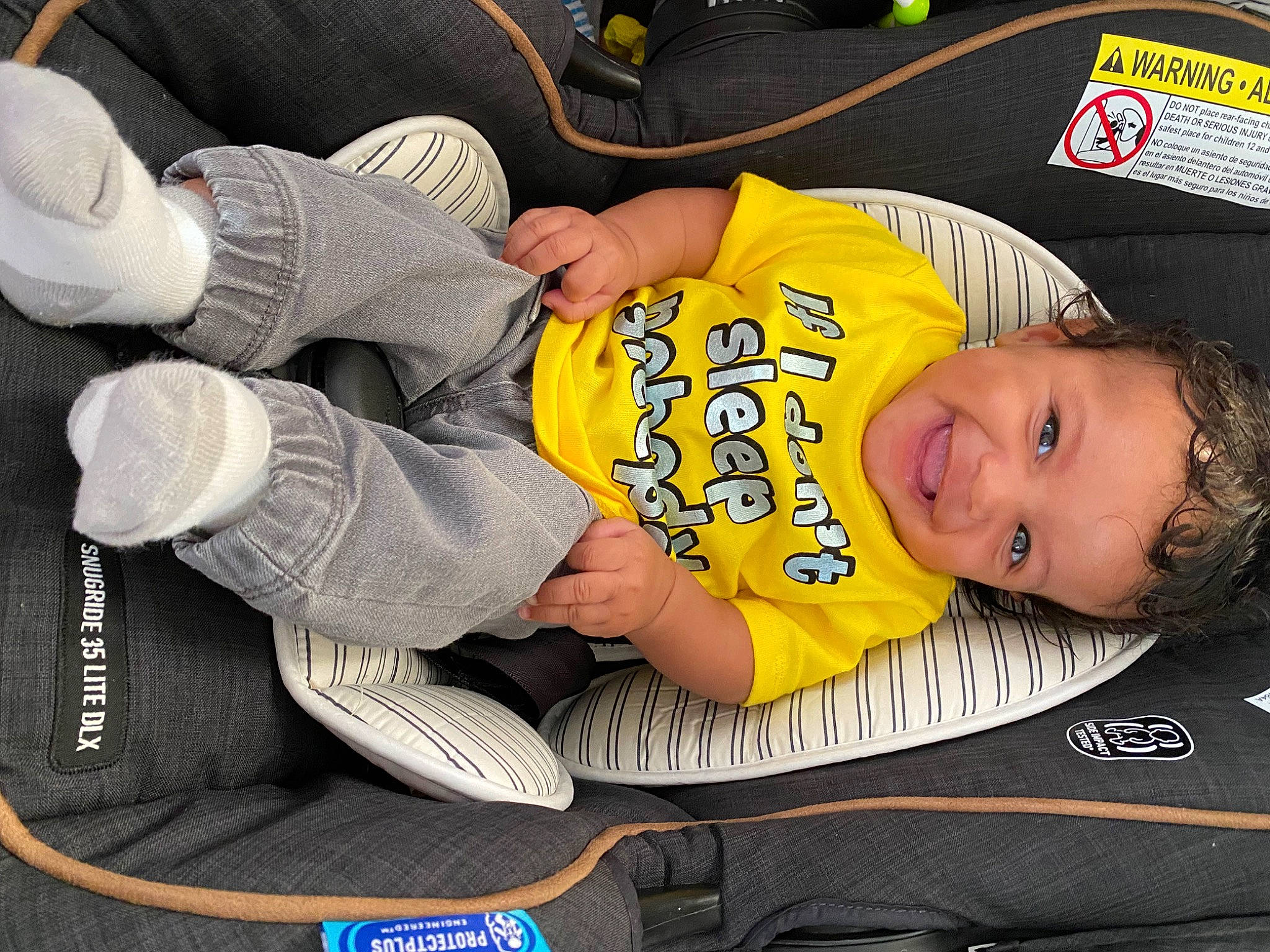 Jaiden is registered to the contest to win money with this photo: arm, baby, baby_products, baby_toddler_clothing, car_seat, child, comfort, elbow, glove, joy, knee, person, sitting, sleeve, smile, sock, sports_gear, sportswear, t_shirt, thigh