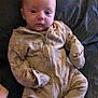 Beau is registered to the contest to win money with this photo: baby, blanket, clothing, coat, couch, cushion, face, furniture, head, homedecor, jacket, newborn, pajamas, pants, person, photography, portrait, sitting, skin, tattoo