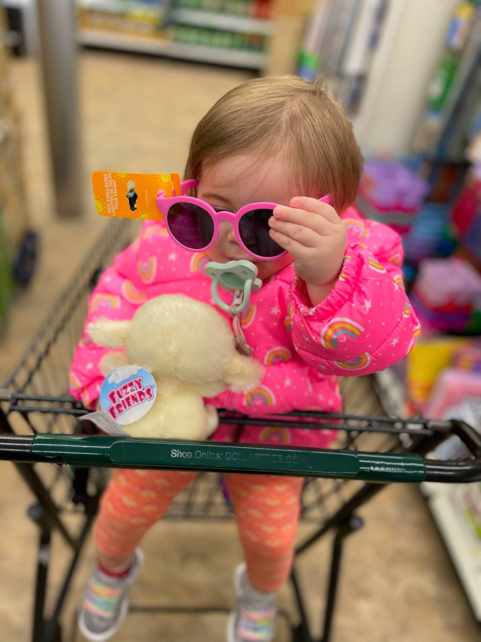 Scarlet is registered to the contest to win money with this photo: baby, baby_toddler_clothing, child, eyewear, fun, goggles, human_leg, leisure, magenta, nail, person, personal_protective_equipment, pink, play, recreation, shorts, sitting, sunglasses, thigh, toddler
