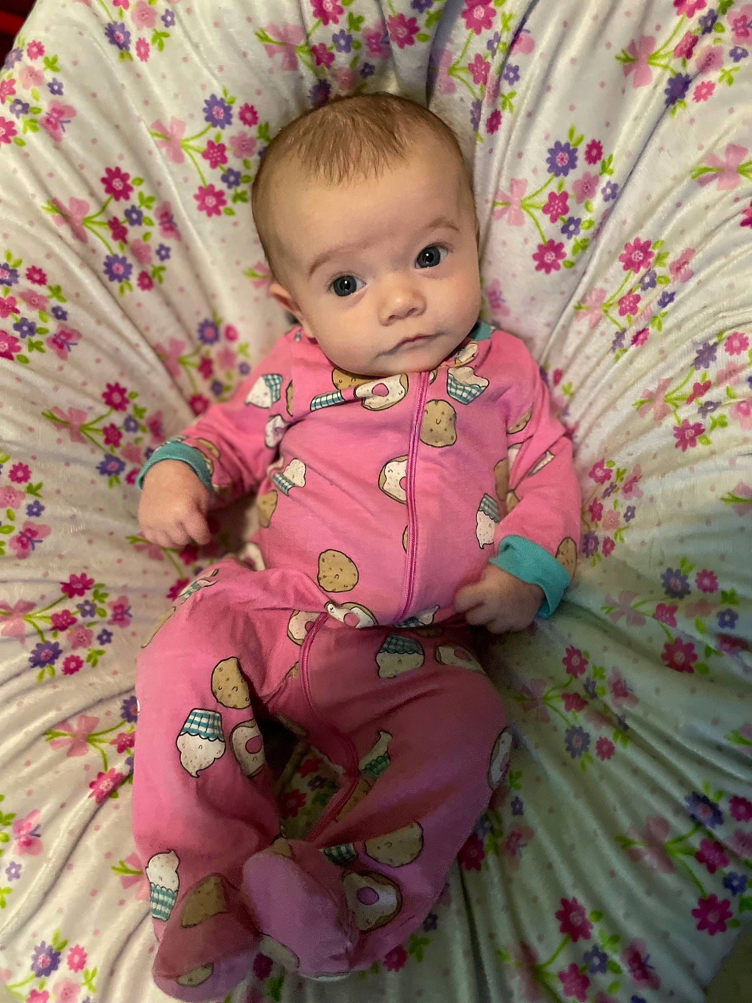 Loralie is registered to the contest to win money with this photo: baby, baby_products, baby_toddler_clothing, cheek, child, dress, embellishment, face, happy, iris, linens, magenta, pattern, person, petal, pink, sitting, skin, sleeve, textile