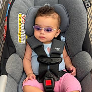 Mazikeen is registered to the contest to win money with this photo: baby, child, car_seat, shopping_cart, sunglasses, pink_pants, blue_top, curly_hair, safety_harness, indoor, retail_store, warning_label, foot, hand, seat_padding, infant, person, cute, fashion, relaxed