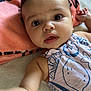 Mazikeen is registered to the contest to win money with this photo: baby, infant, child, face, eyes, arm, blanket, pillow, clothing, pattern, curly_hair, skin, cute, lying_down, indoors, soft_texture, closeup, expression, young, person
