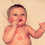 Colson is registered to the contest to win money with this photo: baby, child, infant, smiling, happy, portrait, lying_down, pillow, bed, indoor, denim, jeans, clothing, bare_chest, hand, face, eyes, short_hair, playful, closeup