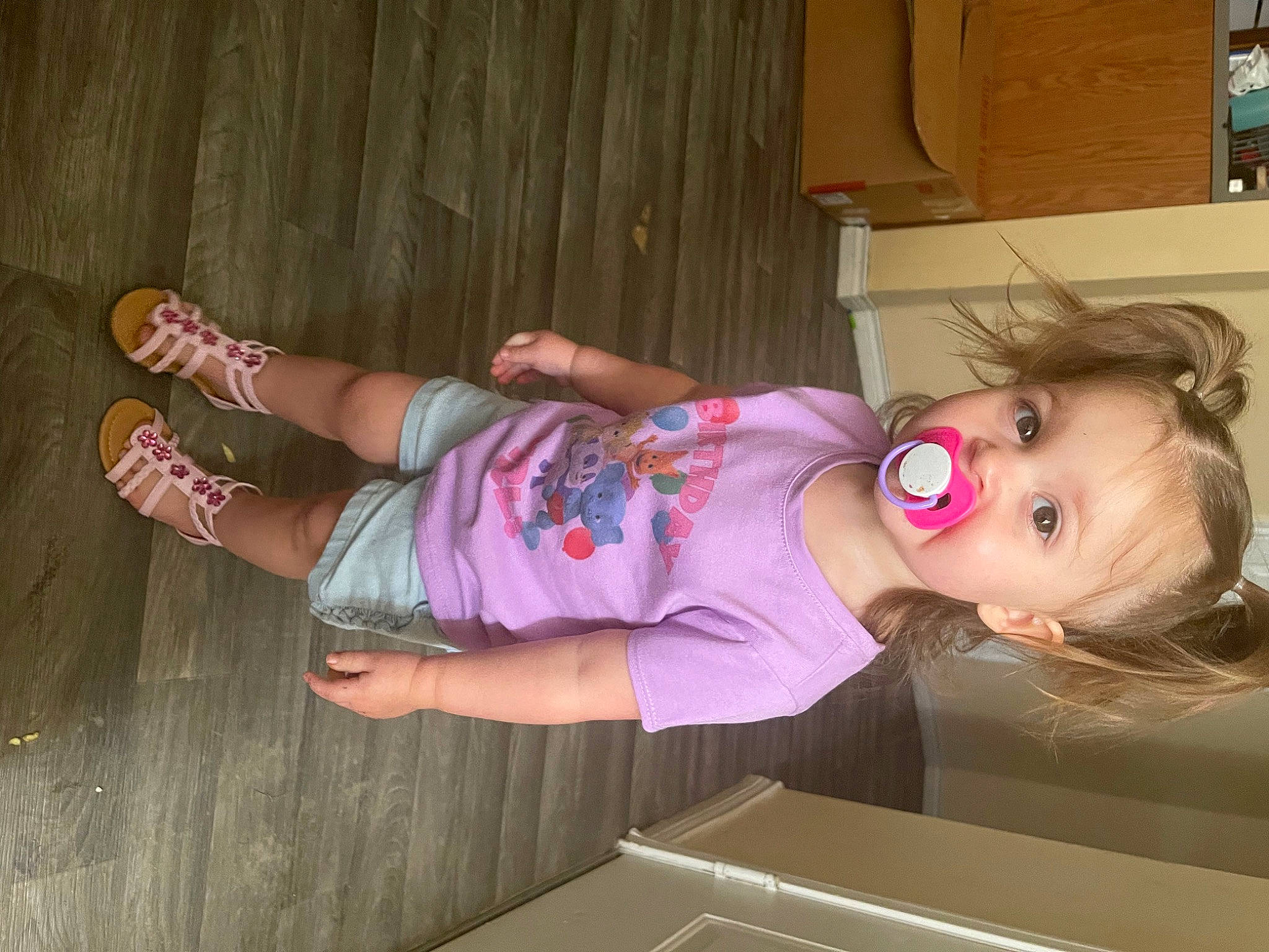 Aspyn is registered to the contest to win money with this photo: baby_toddler_clothing, cabinetry, chest_of_drawers, child, drawer, flooring, foot, fun, human_leg, joint, knee, magenta, pattern, person, pink, room, sandal, sock, thigh, toddler