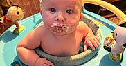 Slade joined the competition — help win amazing prizes! baby, child, messy_face, blue_walker, toy, indoor, floor, bed, wooden_floor, curious, person, infant, play, colorful, plastic, furniture, young_child, looking_at_camera, sitting, cute