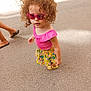child, toddler, curly_hair, sunglasses, pink_top, yellow_skirt, yellow_sandals, sidewalk, street, sunlight, person, casual, walking, summer, outdoor, fashion, colorful_clothing, hair, cute, young