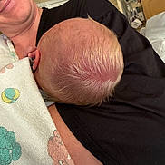 Savanna is registered to the contest to win money with this photo: newborn, infant, baby, sleeping, adult, parent, cuddling, portrait, indoors, hospital_room, blanket, clothing, black_shirt, hair, head, arm, cozy, peaceful, family, nap