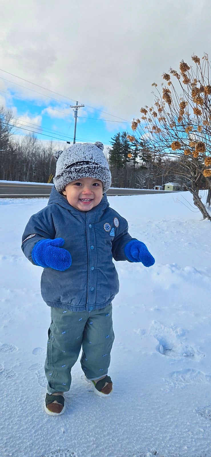 Pedro joined the competition — help win amazing prizes! child, toddler, snow, winter, hat, mittens, blue_mittens, smile, happy, outdoors, jacket, beanie, pants, shoes, footprints, road, trees, sky, shrub, portrait