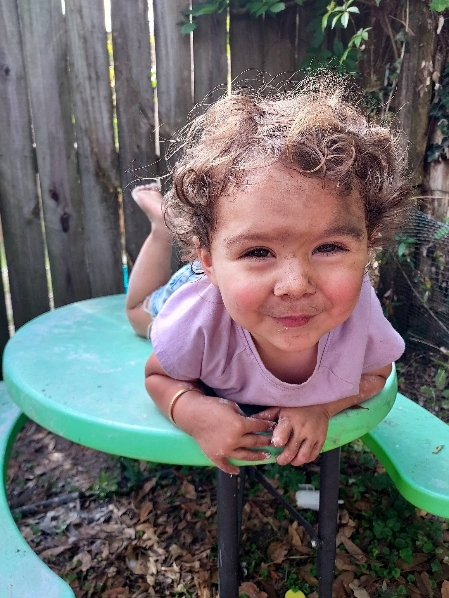 Korra is registered to the contest to win money with this photo: chair, child, face, fun, grass, green, happy, joy, leaf, leisure, outdoor_play_equipment, people_in_nature, person, plant, public_space, recreation, sitting, smile, soil, t_shirt