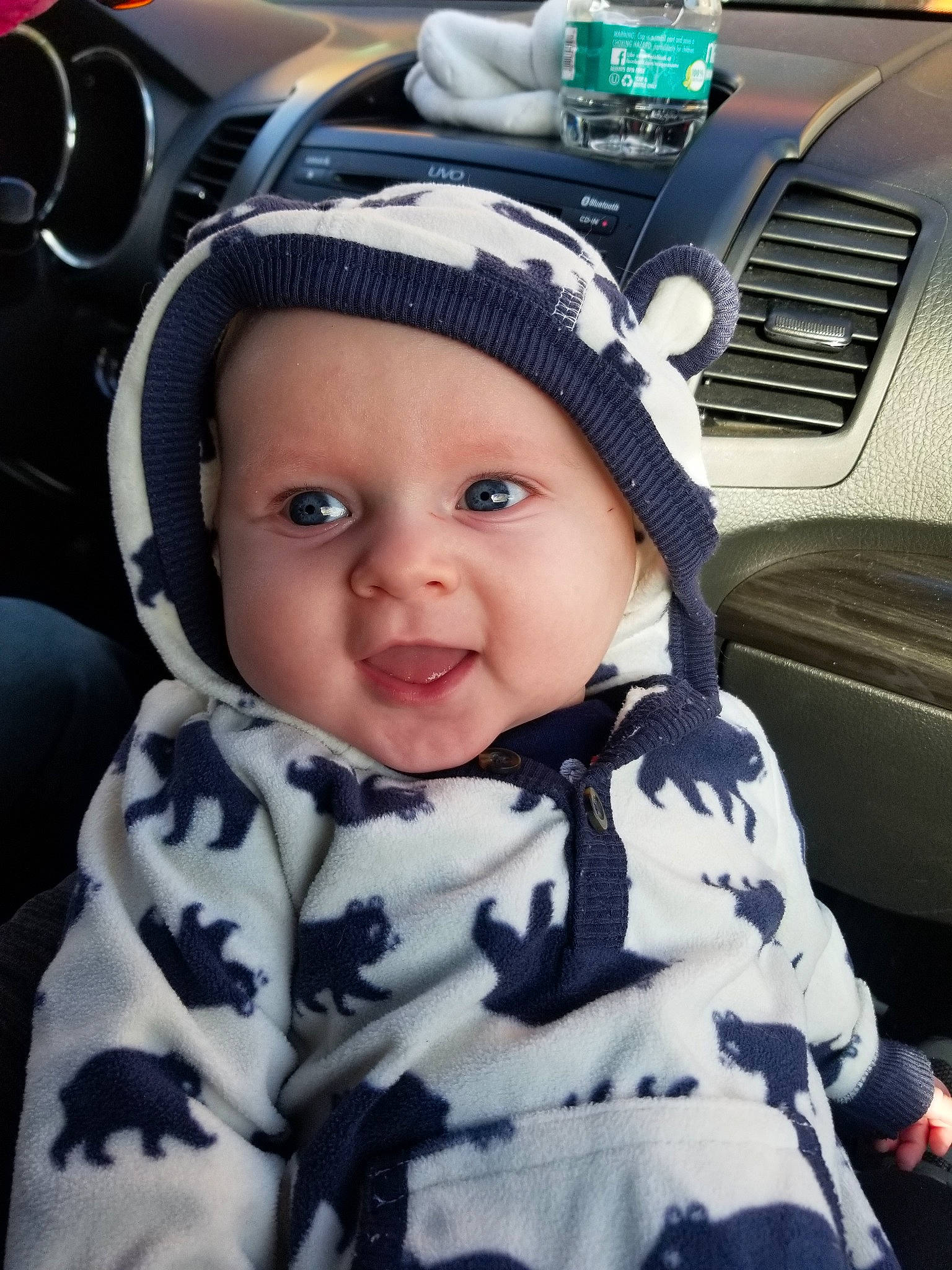 Shawn is registered to the contest to win money with this photo: auto_part, baby, baby_in_car_seat, car, car_seat, cheek, child, cool, ear, hat, head, headgear, person, steering_wheel, toddler, vehicle