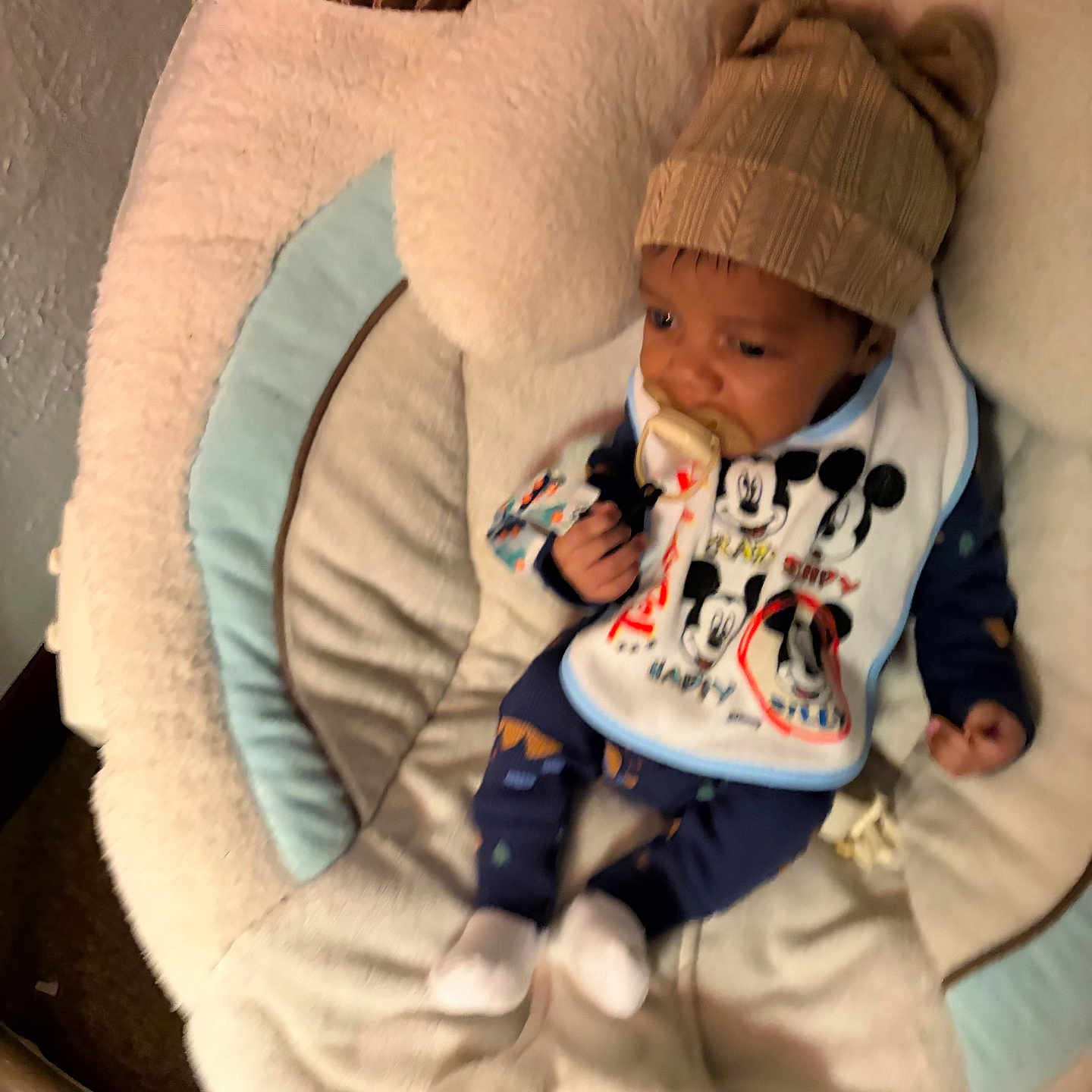Ouetin joined the competition — help win amazing prizes! baby, infant, child, portrait, sitting, rocker, baby_seat, blanket, bib, pacifier, knit_hat, clothing, mickey_mouse, cartoon, indoor, cozy, sleepy, face, hands, feet