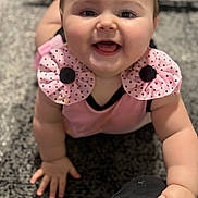 Emma is registered to the contest to win money with this photo: apparel, baby, cheeks, child, close_up, crawling, cute, expression, face, hands, happy, indoor, infant, person, pink_clothing, polka_dot, portrait, skin, smiling, young_child