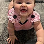 apparel, baby, cheeks, child, close_up, crawling, cute, expression, face, hands, happy, indoor, infant, person, pink_clothing, polka_dot, portrait, skin, smiling, young_child